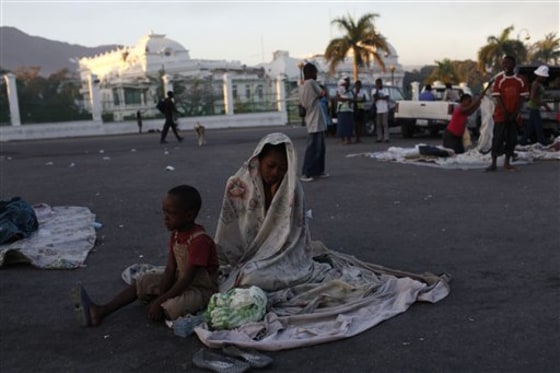 A woman and her son wake up after spending the night on the street in front of the collapsed National Palace in Port-au-Prince on Saturday.